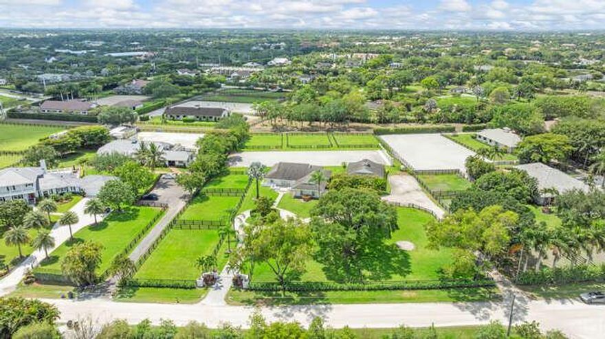 This exceptional dressage farm is located in Wellington's prestigious Saddle Trail neighborhood, just steps from the bridle path and a short hack to the showgrounds. The impeccably maintained property features a 5-stall barn with Softstall system, feed and tack rooms, fly spray system, lounge, bathroom, and washer/dryer; ideal for seasonal staff or grooms. The farm offers multiple shaded paddocks, mature trees, and ample trailer parking, along with a top-tier regulation dressage arena featuring Riso footing and mirrors. The main residence includes an open floor plan with 3 bedrooms and 2 baths, impact windows and doors, and a whole-property generator. A rare opportunity to enjoy Wellington's premier equestrian lifestyle with comfort, convenience, and high-end amenities!