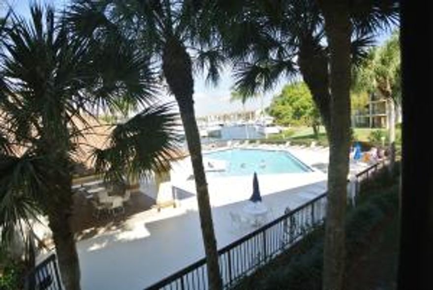 Beautiful Bluffs Marina Condo with pool and Marina views. Newer carpet and paint. Water, sewer and basic cable included. Large Living Area, Dining Area, Breakfast Bar, Large Bonus/Laundry Room-Great for Storage-Office or Overnight Guest. Enjoy a game of tennis on the newly refinished courts, day or night or enjoy any of the 4 Waterfront Pools. Beautiful tropical landscaping professionally maintained. Winding sidewalks throughout the complex are great for walking or a safe off-street bike ride with beautiful Water Vistas.