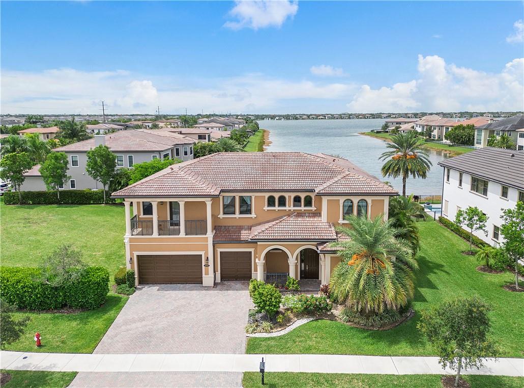Stunning & spacious 6 bed+office+bonus room, 4.5 bath Barrington model w/3 car garage, 1/2 acre corner yard, pool w/spa & spectacular long lake views! This contemporary masterpiece w/ large living areas has over 5300 sq ft. Upgraded & open Kitchen w/ stainless range hood, gas stovetop, oversize fridge, double oven, large center Island & walk in pantry. Custom built-ins in dining room. Upstairs Master Suite w/2 Custom built in walk in closets w/ sitting area. Wood staircase. Marble & wood floors, upgraded fixtures, fans & window treatments plus impact glass throughout. Must see to believe this amazing home w/ volume ceilings, crown moulding, natural gas & fenced backyard, Maintenance includes lawn care. Enjoy amenities including resort pool, clubhouse, gym, tennis & more!