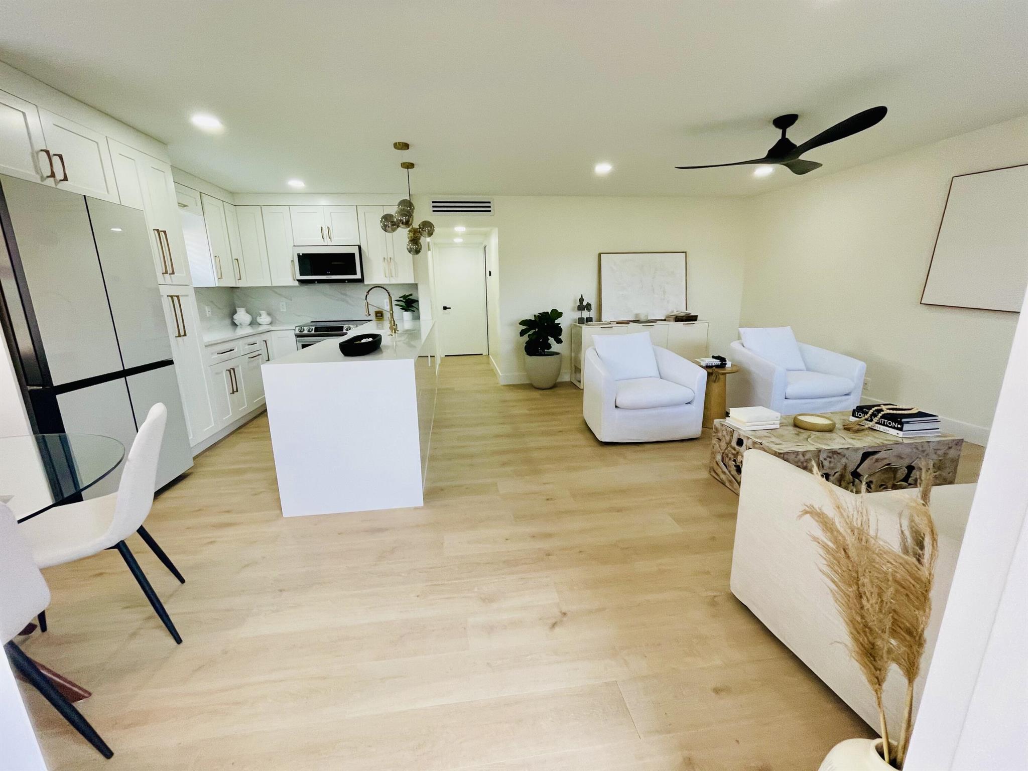 This is a new and custom designed Villa that you must see! Be the first to enjoy this brand new villa on the water, it has never been lived in post updating.Stunning quartz countertops w waterfall, designer backsplash w matching under counter design. Real wood soft close cabinets, garbage pull out, double pantry with extra storage.Large fireclay apron sink w/ Kraus faucet air built in air switch and soap dispenser.30 bottle built in wine fridge.High end Bespoke Samsung appliances are all brand new. Engineered hardwood flooring throughout.Spa like frameless shower bathrooms.Frosted glass pocket door separating bedrooms for an ensuite feel. Recessed lighting throughout, ceiling fans and designer chandelier.AC,Water heater,Nest A/C brand new.HVHZ rated sliders with built in blinds.