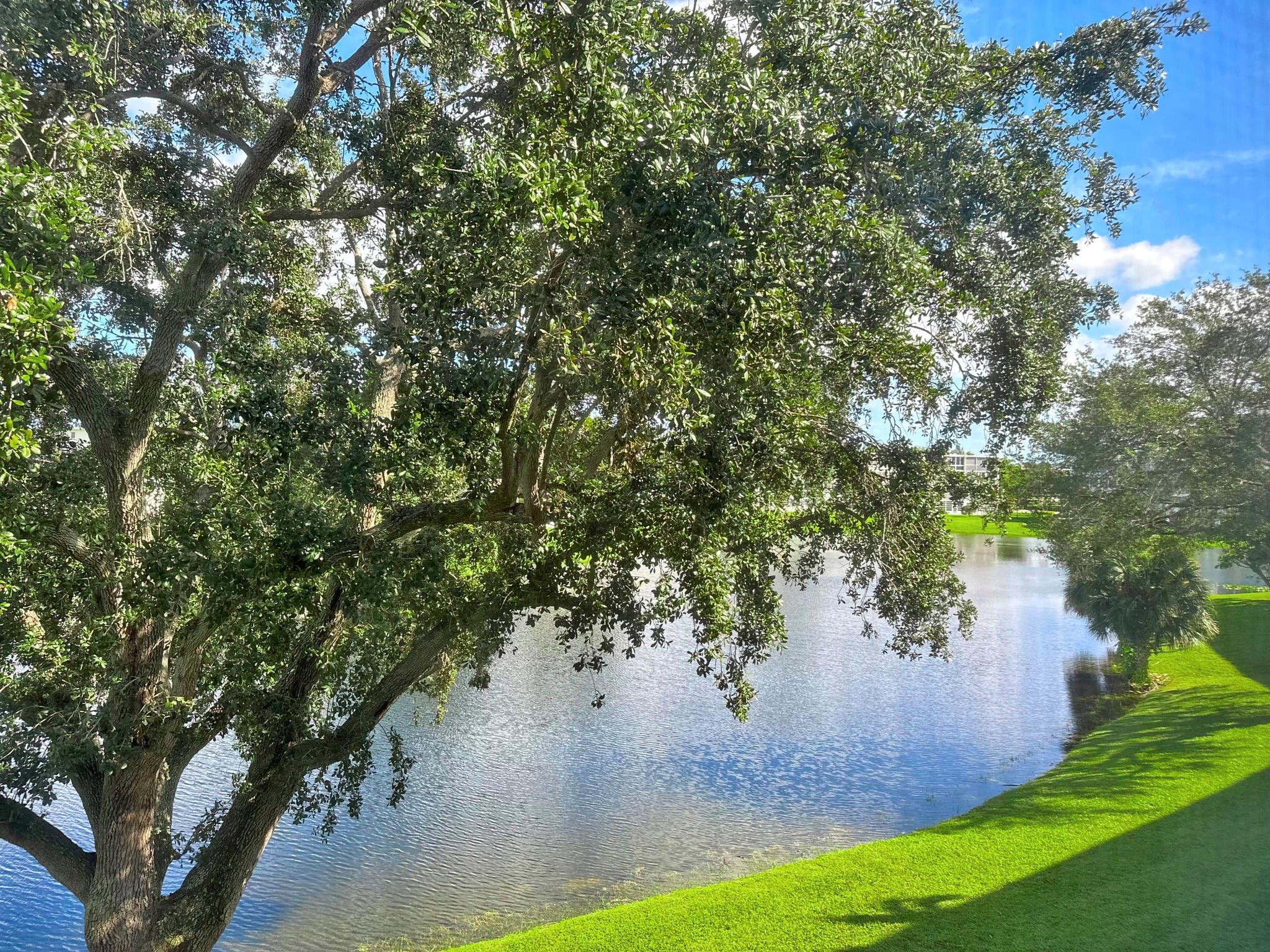RARE CORNER in the prestigious GRANTHAM AREA! Lovely LAKE VIEW from this 2 bedroom, 2 bath luxury condo on the 2nd flr. Walking distance to clubhouse & pool, it doesn't get better than this! FULLY FURNISHED & ready to move in, this unit has many upgrades incl. OPEN KIT w/granite counters, SS appl (new fridge), subway tile backsplash, white shaker cabs, recess lts, & ext. cabinetry in din rm for ext. storage. Tile flrs thru-out open area & wood plank tile flrs in bedrms. A/C is 1 yr old & updated elect panel. Lg encl patio overlooking beautiful water view! Enjoy this gated comm w/ 24/7 security, pools, tennis, pickleball, putting green, bus service, State-of-the-Art Clubhouse w/gym, classes, clubs, cafe, indr/outdr pools, billiards & more! Min to Shopping, dining & Beach. Assoc. Claims 55+