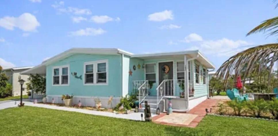 Not your standard mobile home!Remodeled with an open floor plan. Features a Kitchen Island, New Appliances, Fireplace & 60'' TV , Impact Windows, Walk-in Closet, New Vinyl Flooring,and so much more! With over $50,000 in recent upgrades (not including the labor), this home radiates elegance and class: *Impact double-hung windows with custom blinds $17,000*All new sub flooring, LVP flooring, and drywall $10,000*All new upgraded kitchen cabinets, sink, counter tops, enhanced appliances & Custom built Pantry over $8,600 *Bathrooms remodeled, new tile, vanities, and shower over $3,000*Custom Itched doors & Custom Built Mirrored-Stone Wall $4,800*Stone Patio areas $7,000AND MANY OTHER CUSTOM TOUCHES !