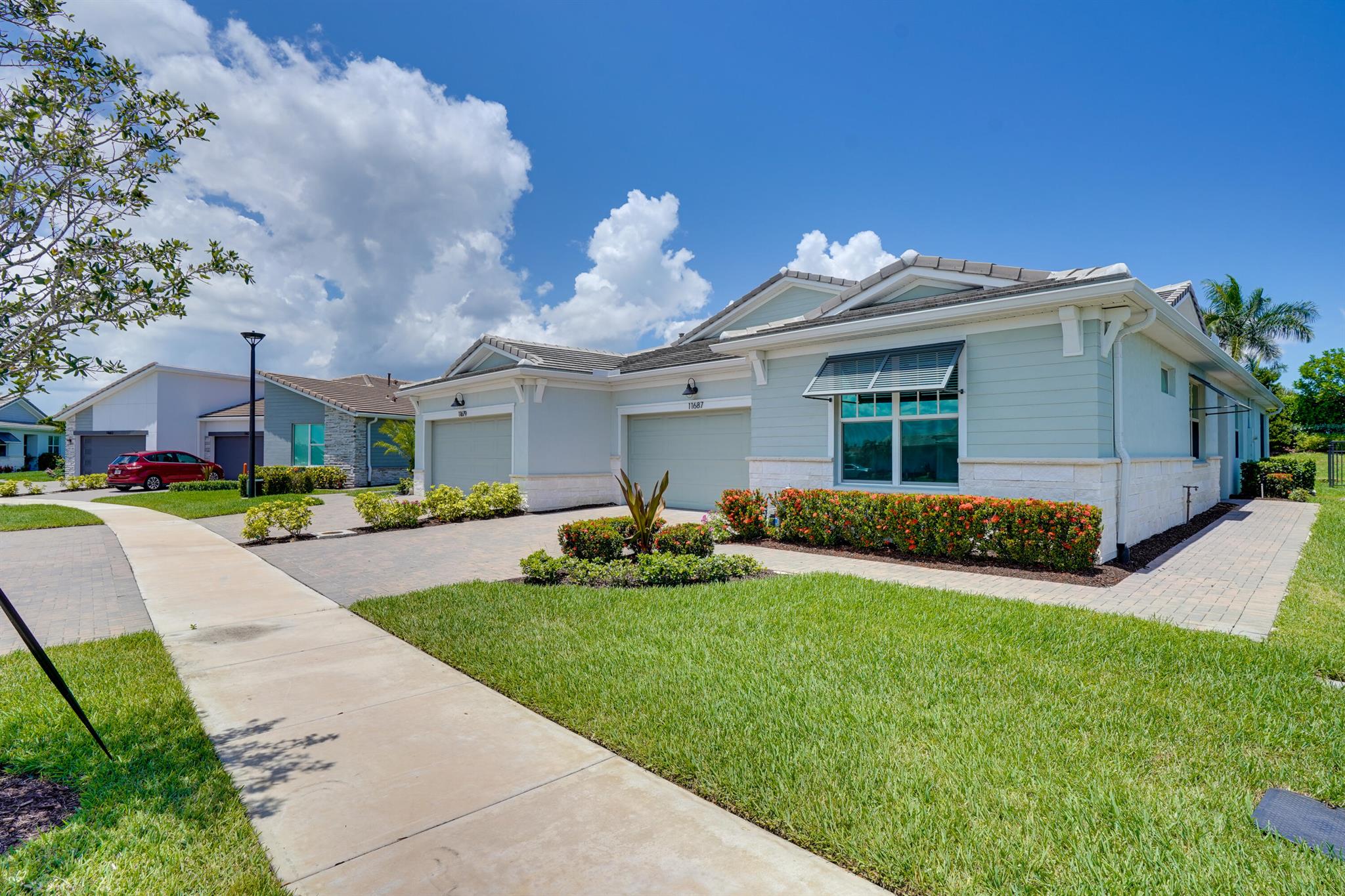 Stunning move-in-ready villa in the gated community of Telaro at Southern Grove in the heart of Tradition. Everyday will feel like a vacation living in this newer construction home with access to the resort style amenities right at your fingertips. This home features 2 Bedrooms, 2.5 Bathrooms and a Den. This well appointed villa features wood-look tile flooring throughout the main living areas. Large kitchen featuring a gas range, long quartz countertops, a center island with room for barstools and a spacious walk-in pantry. The open concept living and dining area offer flexibility to fit an oversized sectional and large dining table. Natural light shines throughout and all windows feature convenient zebra blinds. Impact windows throughout. Screened patio with private backyard and lush
