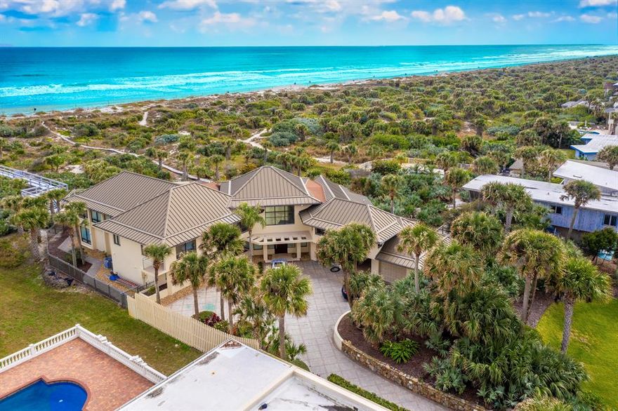 Private ocean front estate. Located in up and coming New Smyrna, FL, North Beach on 1.7 acres of ocean front property. This compound comes with 3,4, or 5 bedrooms with 3 full baths and 2 half baths. The entryway to the property is a gated driveway that leads to this sought after compound. You can enter the glassed in garage showroom or through the homes main atrium. Upon walking in your new home you will see floor to ceiling hurricane impact windows that bring in natural sunlight all day. There are 3 separate living areas. With one being ground level and 2 upstairs making this concrete poured architecturally redesigned fortress truly unique. Enjoy the breathtaking ocean sunrises, walks on the beach, pool/jacuzzi, and the starry nights making this resort style home the ONE