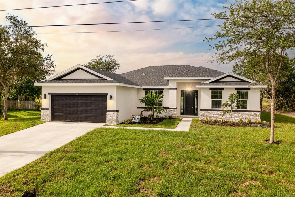 Photo of 3991 SW Wycoff Street, Port Saint Lucie, FL 34953 (MLS # R10985839)