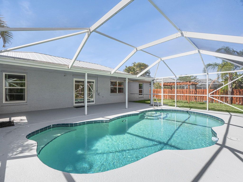 Photo of 509 SW Feldman Avenue, Port Saint Lucie, FL 34953 (MLS # R11125660)