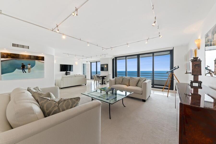 The phenomenal ocean views are striking from the moment you enter this 10th floor paradise! This contemporary 3 bedroom, 3.5 bath unit has fabulous updates galore! The open & airy living spaces feature custom light fixtures, oversized tile & endless ocean vistas. The kitchen features high-end stainless steel appliances with sleek modern cabinetry, custom glass backsplash & an eat-in area overlooking the ocean. The primary suite has stunning city views & includes plush carpeting, 2 walk-in closets with designer built-ins and a gorgeous bathroom with marble details, glass walk-in shower, spa tub and custom vanity. Each guest suite has incredible city views and beautiful ensuite bathrooms; one suite includes carpet and the other suite (utilized as an office) includes hardwood floors.