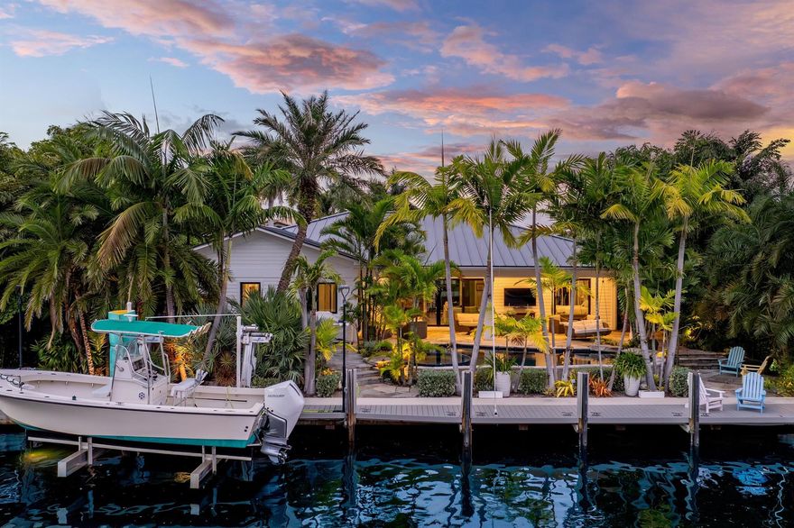 An incredible waterfront residence minutes from the Boynton Beach Inlet is a rare gem. Located in the exclusive boating community of Boynton Isles at 940 Greenbriar Drive, this immaculate 3 bedroom, 2.5 bathroom single-story modern home was completely rebuilt in 2019 with all new plumbing, electrical, and structural components, offering everything needed to live the ideal Florida lifestyle at its finest. With 90 feet of direct water frontage, this home provides no fixed bridge access and sits just two miles from the inlet. Perfect for outdoor entertaining is a nature-infused luxurious backyard surrounded by lush landscaping.