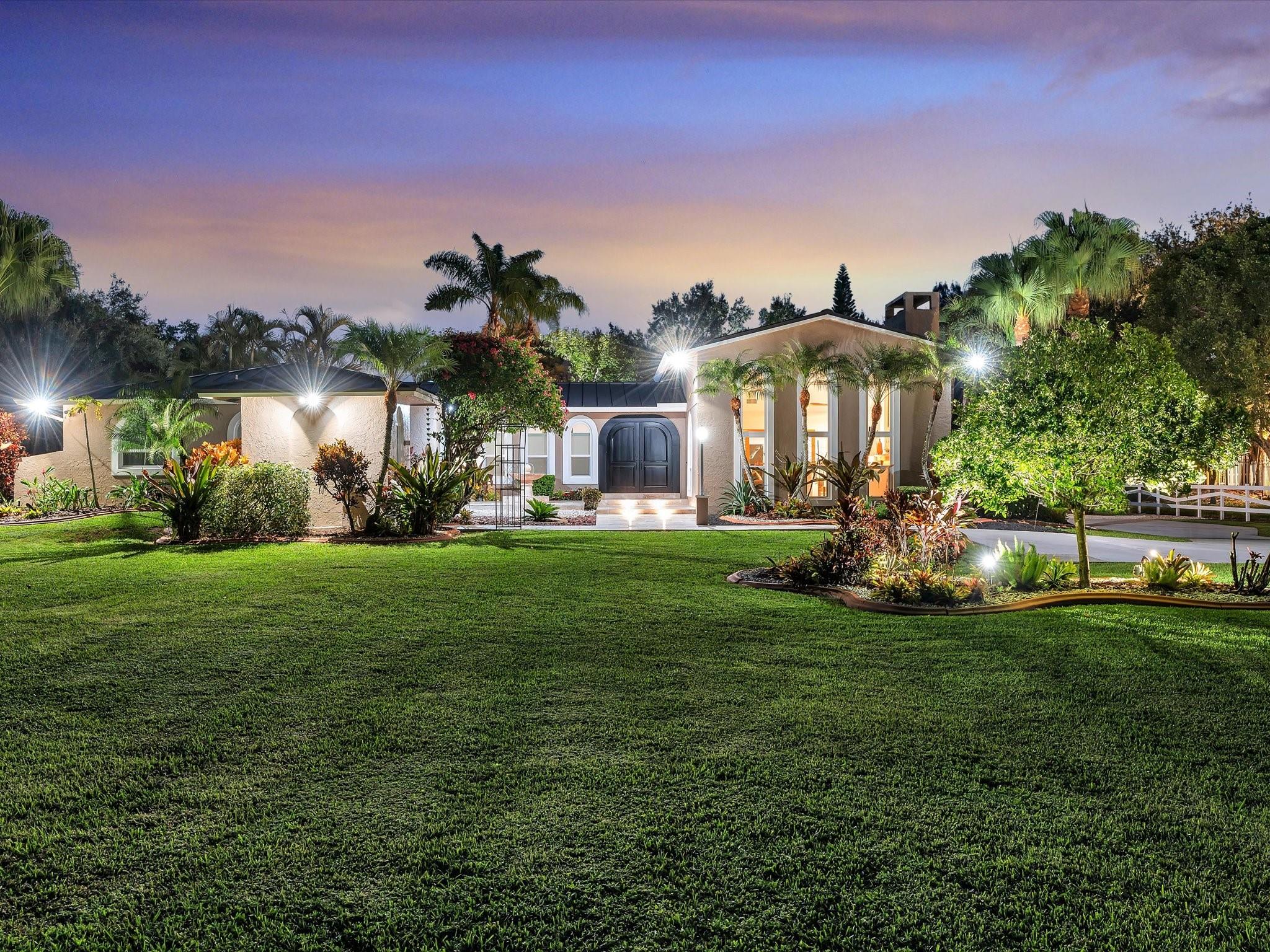 Unique Equestrian residence in Sunshine Ranches, Main house offers 4 beds, 3 baths, over 3,000 SF, a gourmet kitchen, porcelain floor throughout, impact windows, updated kitchen and baths, and a new metal roof. Detached 1 bed/1 GH 620+ SF. Adt. Structure with 1,600+ SF under A/C. Pole Barn with 4 stalls, tack/office room, feed room, storage. Equestrian amenities include a professional riding arena, 4 large paddocks, 2 covered wash racks. Pool, and expansive patio gazebos for entertaining. Complete irrigation system, electric private gated entrance, security systems, fully fenced and professional landscaped grounds on 2.3 Acres. Fully renovated with no expense spared. Zoned for privacy, recreation, and equestrian use, ideal for multi-generational living, entertaining, or income potential.