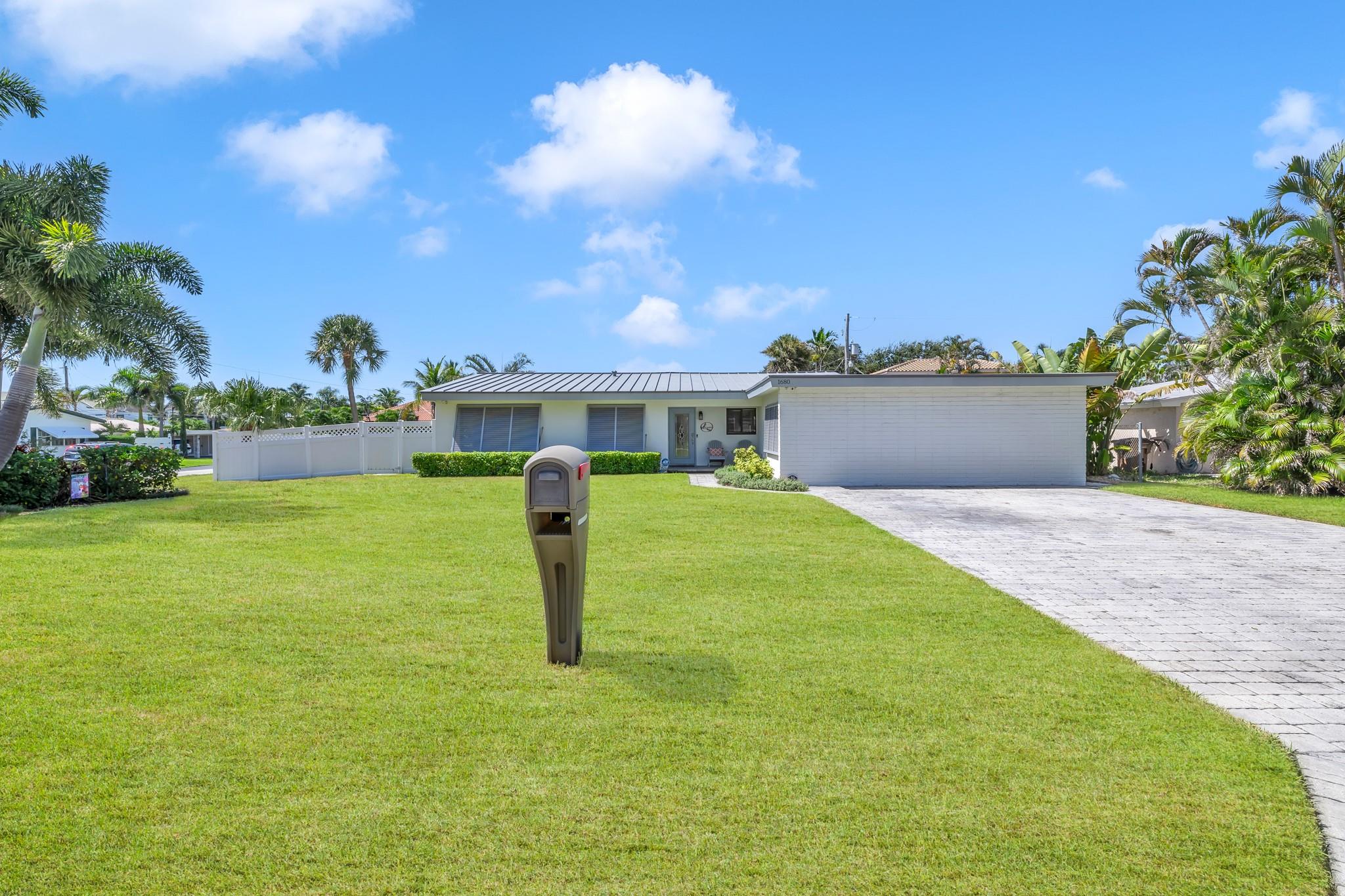 Welcome to this rare opportunity in the highly desirable Cove neighborhood of Deerfield Beach. Situated on an oversized corner lot, this home offers exceptional privacy and just a short walk to The Cove Shopping Center, boating marina, sand & ocean.
Inside, you'll find all impact windows, a durable metal roof, a brand-new water heater, and freshly painted interiors. The kitchen is equipped with Whirlpool appliances (3 yrs old), and each bedroom features customized cedar-lined linen closets. The converted garage, with its own private side entrance, presents endless possibilities—perfect for a guest suite, home office, or additional living space. Enjoy the Florida lifestyle year-round in the screened-in lanai with a covered roof, spacious backyard with more room to add a pool.