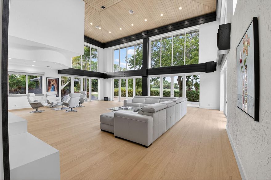 Experience unparalleled luxury in this custom estate situated on a premier double golf-view lot in Oakbrook at Boca West. This freestanding masterpiece offers stunning western exposure and unmatched sophistication. The grand entry reveals expansive living areas, glass railings, and a private elevator. The chef's kitchen is a dream with JennAir appliances and Quartzite countertops. Relax in the lavish primary suite with his & her bathrooms, or utilize the dedicated office. The second level features three ensuite guest bedrooms and a loft. Entertain in your custom media room, luxury bar, or on the screened-in porch. Outdoors, enjoy a resort-style marble patio with a tropical pool and spa overlooking the course. With a circle driveway and 3-car garage, this home defines luxury living.