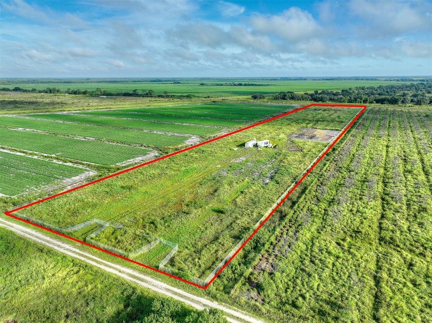 Rare 9.71-acre fenced agricultural parcel in the highly desirable Gerber Groves Section One—ideal for tropical fruit farming, livestock, or a private retreat. Features include a man-made lake for animal hydration, canal along the north boundary, and a 40-ft cargo container. Partially cleared with fertile soil and existing grove trees, suitable for mangoes, lychees, longans, bananas, papayas, dragon fruit, passion fruit, bamboo, and much more. Located in the Gerber Water District with irrigation water, no HOA, and added security. Private dirt and gravel road access offers seclusion, yet only 45 minutes to I-75. Perfect for serious farmers and investors seeking productivity and long-term value.
