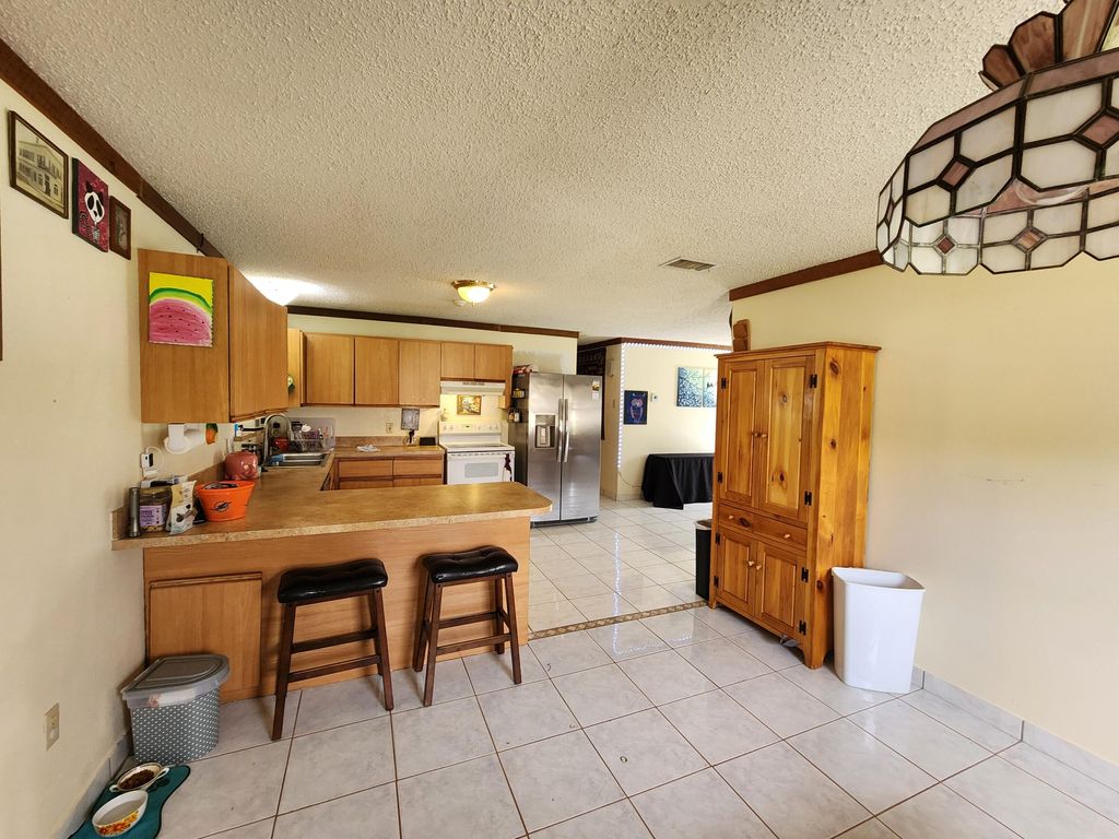 Photo of 1821 SE Dranson Circle, Port Saint Lucie, FL 34952 (MLS # R10958295)