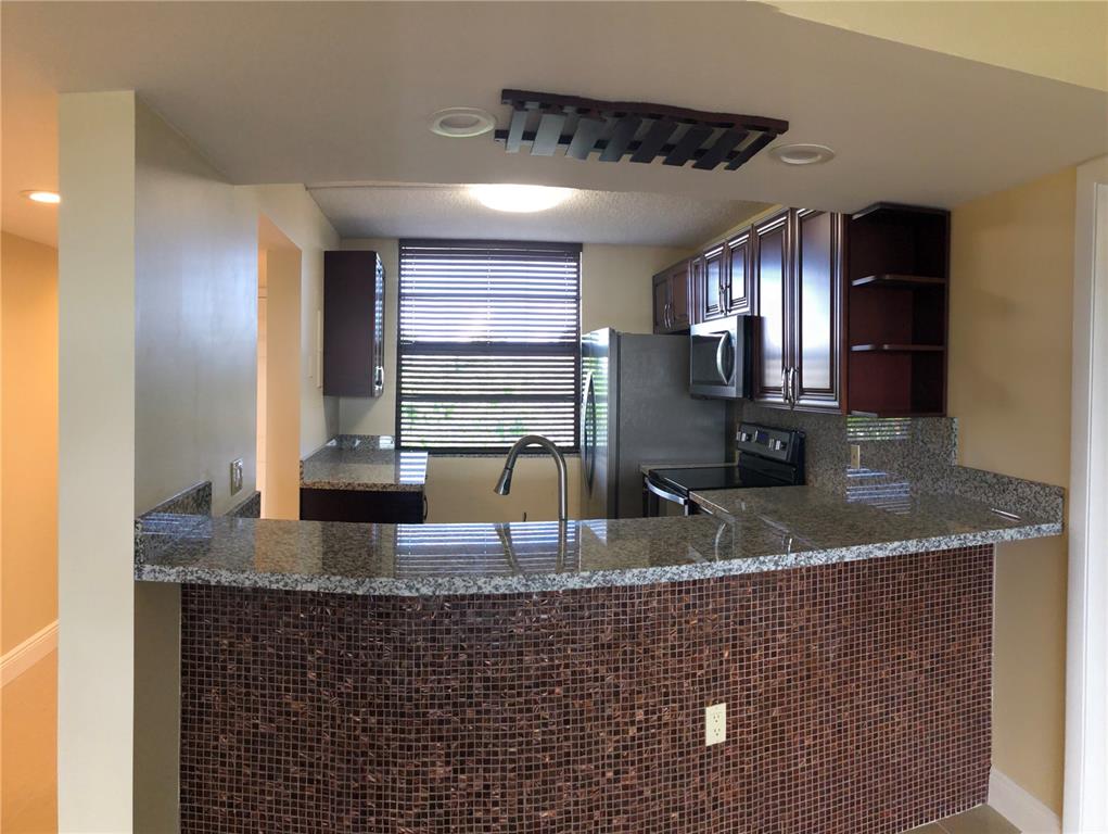 BEAUTIFUL 2BR/2BA WITH EXTRA ROOM THAT CAN BE USED AS A DEN OR OFFICE. WASHER DRYER IN UNIT. UNIT HAS BEEN TOTALLY RENOVATED. BEAUTIFUL 24 X 24 PORCELAIN FLOORS, BRAND NEW WOOD KITCHEN, WITH GRANITE COUNTERTOPS BRAND NEW WHIRLPOOL STAINLESS STEEL SMUDGE FREE APPLIANCES, NEW TILED SHOWER & BATHROOM, NEW VANITIES. IMPACT WINDOWS. COMMUNITY OFFERS FULL AMENITIES SUCH AS GOLF COURSE, POOL, TENNIS, FULL SERVICE RESTAURANT, PLUS CHIPPERS RESTAURANT, PUTTING GREEN AND MUCH MUCH MORE. THIS IS A HIDDEN GEM IN DAVIE. THIS UNIT IS ALSO AVAILABLE FOR RENT. AT $1975 PER MONTH MLS # H10358763