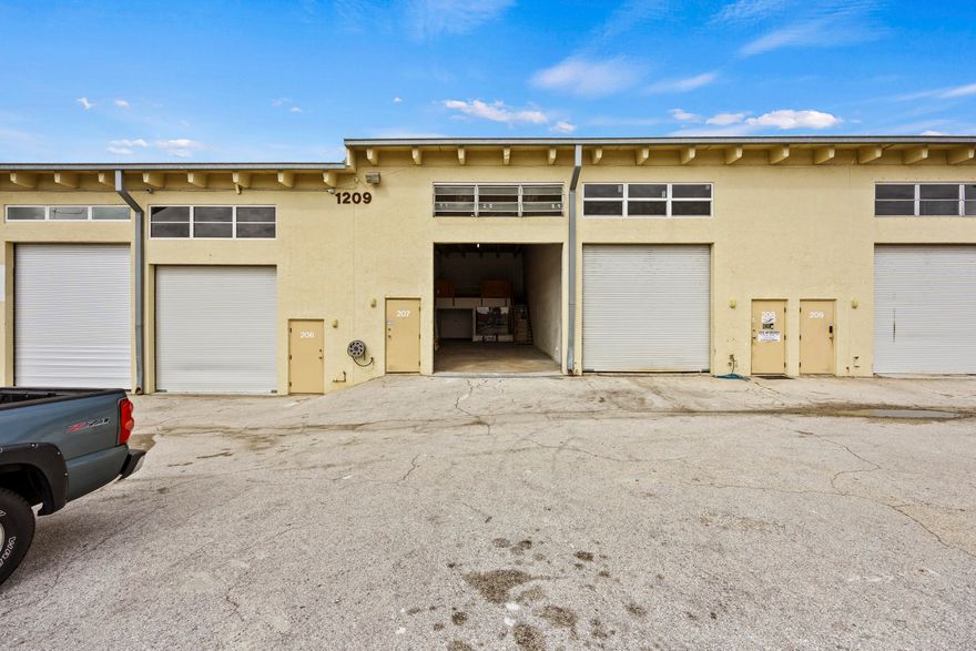 Perfect for RV storage, Boat storage, Small Business or Build a man cave. Long vehicles can driven in from the main road with ease. 5 minutes from I-95 (Northlake Blvd) and 10 minutes from Riviera Beach Boat Ramps. 

The unit offers 1,100 square feet of space with dimensions of 20 feet by 55 feet. It includes a bathroom with a shower, a loft with stairs, and a concrete ceiling. Quarterly association fees $800.00. The unit is easily accessible and ready for immediate occupancy.

Building to be painted soon with one of the 4 colors seen in the photos. 
    
Association covers exterior insurance, maintenance, and water. There are two dedicated parking spots. The unit allows for an auto-dealers license. There is a Twin-T concrete roof. There is no A/C in the warehouse.