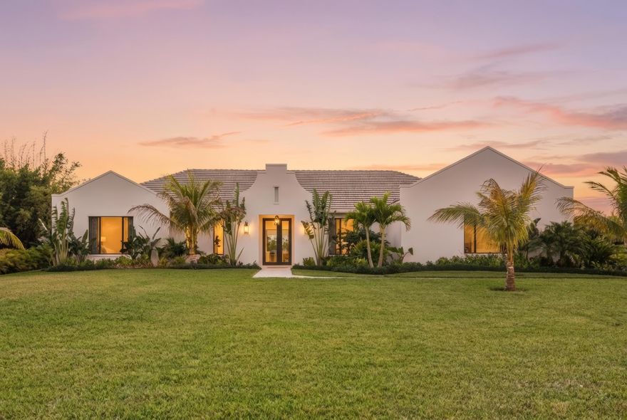 Nestled on 1.25 acres on one of the best streets in Jupiter Farms, this expansive 2024 built custom home will impress the most discerning buyer.  Prime location easy access to I-95, FL Turnpike & amenities of Jupiter! Elegant single-story living: ~3,989 sq ft, 4 beds + playroom/office, 4 baths (3 full & 1 half), mudroom, laundry room, huge walk-in pantry & tons of storage. Premium finishes: white oak hardwood floors, natural stone, 10.5-ft ceilings, 10-ft impact sliders/doors flooding space w/ light & seamless indoor-outdoor flow. Warm modern vibe w/ soft arches, custom mirrors, built-ins, vaulted ceilings, fans & arched plaster isokern gas fireplace w/ herringbone detail. Showstopper chef's kitchen: custom cabinetry, oversized hood, high-end paneled appliances, appliance garage w/ antiqued glass doors & access via fluted glass door to stunning panty...great entertaining flow. The kitchen connects to the formal dining room with seating for 10+ and wine storage built-ins, oversized window with lush garden views & arched access to foyer. Lux primary suite w/ arched entry, 2 walk-in closets, access to backyard & primary bathroom with honed marble, custom white oak double vanity with plaster sconces & Brizo plumbing fixtures. Architectural arched plaster accent wall cocoons the soaker tup for a spa-like experience while separating the walk-in shower & water closer.  All additional beds w/ walk-in closets, spa baths & thoughtful touches. Embrace Florida Resort-style living: covered 574 sq ft loggia w/ retractable bug screens, salt-water heated pool & spa , lush landscape with coconut and xmas palms & serene setting for relaxation/gatherings. Additional features include an oversized 3 car garage, energy efficient impact windows & doors, two-zone A/C, whole-house reverse osmosis system, full property irrigation, 500-gallon propane tank, backup generator ready, Ring security system, CAT4 throughout. Access Riverbend Park down the street & enjoy access to trails, kayaking & nature!