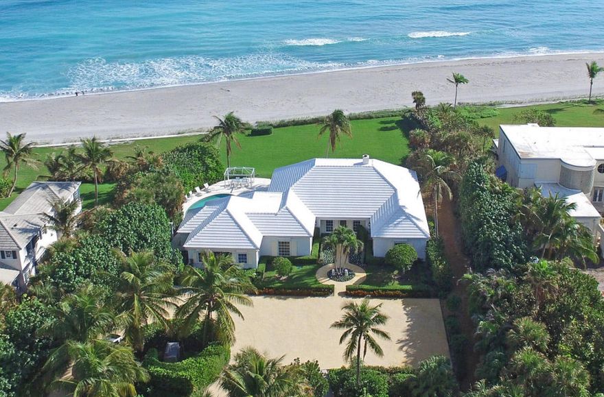 Fabulous beachfront house on 1.5 beautifully landscaped acres in prime Jupiter Island location. This spectacular property includes lovely outdoor spaces designed to take full advantage of the ocean views and breezes. It sits on a high elevation with wide water views and a sweeping lawn down to the sea. Flooded with light and offering significant expansion possibilities. All dimensions are approximate.