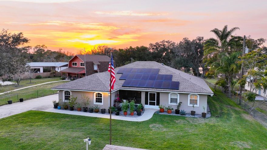 Fisherman & sunset lover's dream on the shores of beautiful Lake Josephine, featuring a private dock w/ boat lift, expansive screened 60' lanai w/ new roof, automatic entry gate & detached two-car garage, w/ over $260,000 in upgrades completed 2023-2025. Enhancements include new roof, complete A/C system & ductwork, remodeled kitchen & bathrooms w/ all-new cabinets & appliances + 9x6 pantry, whole-house water filtration, plantation shutters, screened front porch, enlarged lanai, updated irrigation & well system, new dock, boathouse repairs, new leech field & security system. Open floor plan captures stunning lake views w/ generous living & dining areas, a thoughtfully designed kitchen, & a 3-bedroom, 2-bath layout. Outdoors setting is perfect for fishing, boating & relaxing