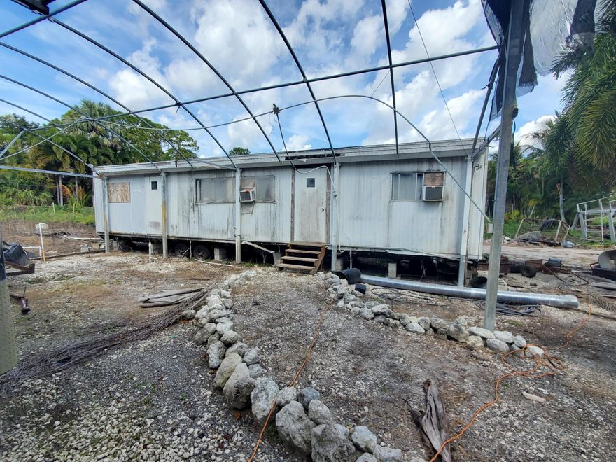 This is a 10+ acre vacant land parcel in Heritage Farms, West Lake Worth, currently operating as a wholesale nursery. This property is a multi-use property with existing infrastructure -- good for buyers seeking rural/ag land in a potentially appreciating area, including an irrigation system with a 5-horsepower electric well water pump, well and canal water access, office, plants, and trees (inventory may convey). Zoning/Allowed Uses: Nursery (wholesale), horses (equestrian/agricultural), residential, and for land development or housing development. This is a ''hidden gem'' and ''great investment--right in the path of progress.''