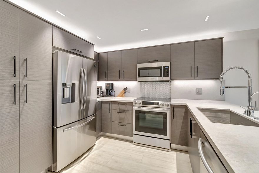 Fully Renovated 2 Bed / 2 Bath Condo in Prime Boca Raton

Welcome to a completely renovated true 2-bedroom, 2-bath condo featuring modern luxury and thoughtful design throughout.

The open kitchen showcases a quartz waterfall peninsula, paired with a black leather-finished granite dry bar and custom matching built-in granite tabletop with under cabinet and accent lighting. Lighting has been professionally designed with multiple zoned switches for walkways, kitchen workspaces, and seating areas. A floating custom media center matches the cabinetry for a seamless look.

Additional upgrades include modern recessed lighting with three-way switching, impact hurricane doors with LOW-E glass for energy efficiency, a filtered drinking water spout and refrigerator connection, a tankless water heater, custom built-in adjustable closets, and a full-size washer and dryer inside the unit.

Both bathrooms feature high-end finishes, including Toto toilets, intricate tilework, a spa-style primary shower with body jets, and a guest shower with a handheld wand.

Ideally located near I-95, Boca's beaches, dining, and shopping, with low-maintenance ownership costs. Plus, Boca Paddle by CityPickle debuts in 2026 nearby, offering luxury indoor pickleball and padel courts with resort-style amenities.