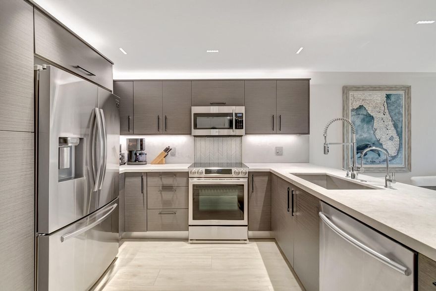 Fully Renovated 2 Bed / 2 Bath Condo in Prime Boca Raton

Welcome to a completely renovated true 2-bedroom, 2-bath condo featuring modern luxury and thoughtful design throughout.

The open kitchen showcases a quartz waterfall peninsula, paired with a black leather-finished granite dry bar and custom matching built-in granite tabletop with under cabinet and accent lighting. Lighting has been professionally designed with multiple zoned switches for walkways, kitchen workspaces, and seating areas. A floating custom media center matches the cabinetry for a seamless look.

Additional upgrades include modern recessed lighting with three-way switching, impact hurricane doors with LOW-E glass for energy efficiency, a filtered drinking water spout and refrigerator connection, a tankless water heater, custom built-in adjustable closets, and a full-size washer and dryer inside the unit.

Both bathrooms feature high-end finishes, including Toto toilets, intricate tilework, a spa-style primary shower with body jets, and a guest shower with a handheld wand.

Ideally located near I-95, Boca's beaches, dining, and shopping, with low-maintenance ownership costs. Plus, Boca Paddle by CityPickle debuts in 2026 nearby, offering luxury indoor pickleball and padel courts with resort-style amenities.