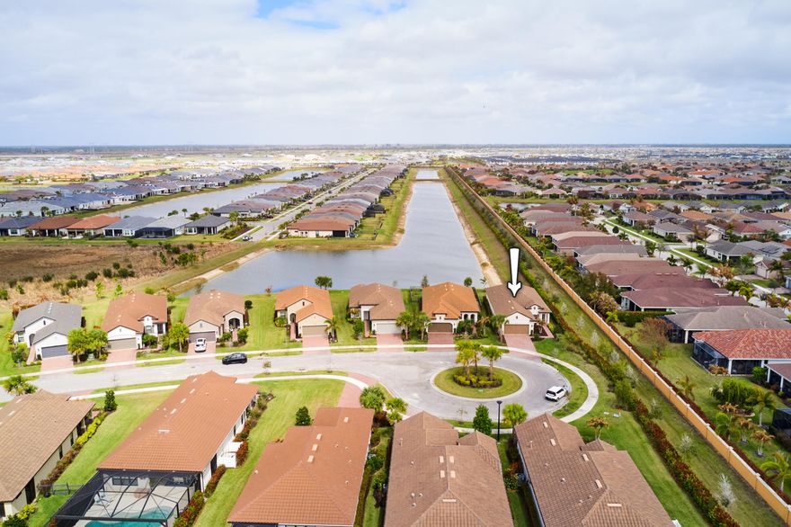 Tranquil lake views set the tone for this beautifully upgraded 3BR/2.5BA home, perfectly positioned on a cul-de-sac in the completed section of Esplanade at Tradition. Designed for comfort and effortless living, the open layout features 18x18 tile flooring in the living areas and a dramatic three-panel multi-sliding door that opens to a screened lanai overlooking the water. The kitchen is thoughtfully appointed with quartz countertops, 42'' cabinetry with crown molding, a custom pantry, and a full suite of GE Profile appliances. The expansive primary suite enjoys peaceful lake views, enhanced carpeting, a spa-like bath with double sinks and walk-in shower, and a custom built-out closet. The third bedroom, currently used as an office, features beautiful engineered hardwood flooring. The screened lanai, plumbed for a future outdoor kitchen, is perfect for morning coffee or relaxing sunset evenings. Thoughtful upgrades throughout make this home truly move-in ready.