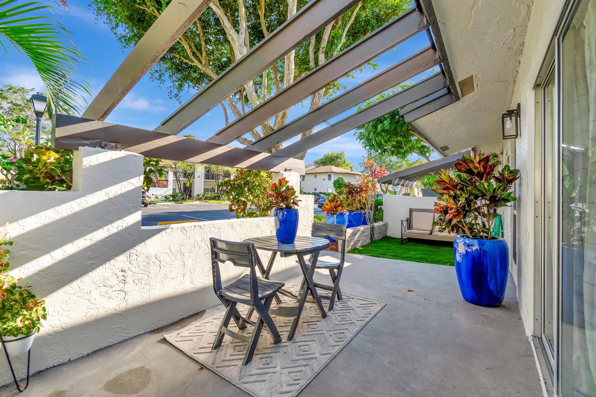 This breathtaking one story villa has it all! Enjoy a perfect combination of indoor/ outdoor living space with serene lake views. Nestled on a quiet street with ample parking for your convenience. Upon entry, there is a charming patio area adjacent to the front door. You will notice this home is a smart home with panels in each room controlling lighting and fans. There is contemporary detail and designer quality wrapped in high end finishes throughout. The kitchen features Samsung Bespoke appliances, a large porcelain island, porcelain tile and an open concept for entertaining guests. The spacious Primary bedroom overlooks an outdoor screened patio and features a custom bathroom with double sinks, led lighted mirrors and a separate toilet area and walk in closet. Come See for Yourself!