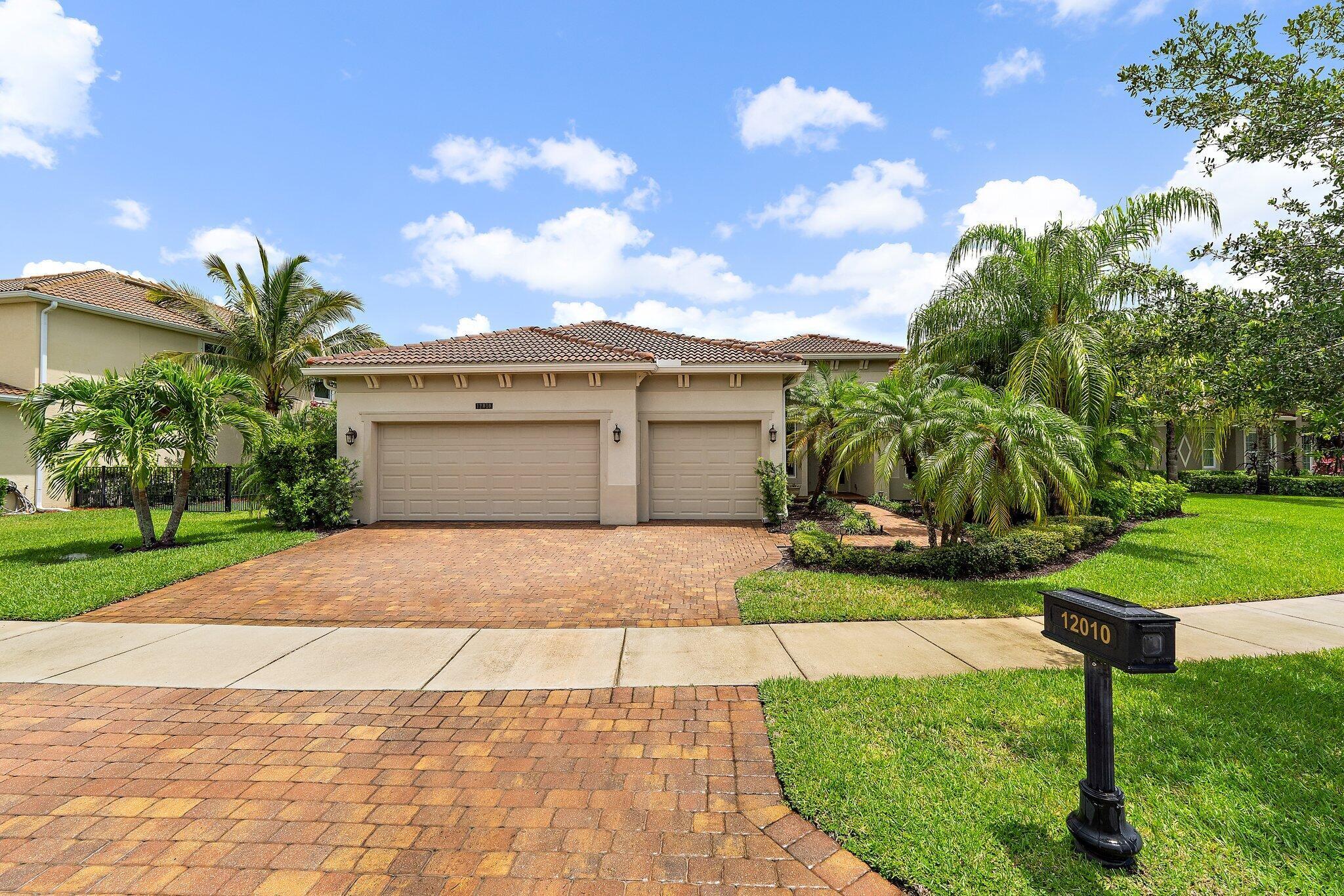 Exceptional DiVosta Ballister model in the prestigious Estate section of Tradition. Set on an oversized lot, this home features 10' ceilings and 11' tray ceilings in key rooms, offering a bright, open feel and extra vertical storage. The gourmet kitchen boasts granite counters, stainless steel appliances, and custom cabinetry. The spacious primary suite includes dual walk-in closets and a spa-style bath. Outside, enjoy a covered lanai, lush landscaping, and room for a pool. Premium-finished garage is ideal for storage or hobbies. Gated community with low HOA, minutes from Tradition Square, shopping, dining, Cleveland Clinic, and I-95.