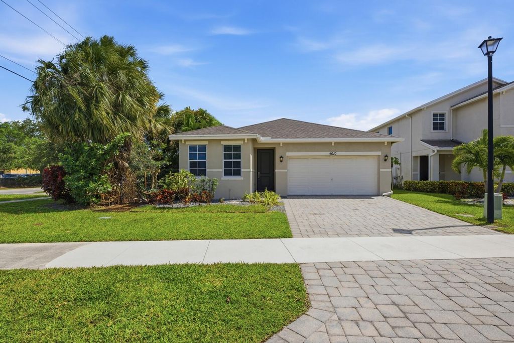 Photo of 4010 Tomoka Drive, Lake Worth, FL 33462 (MLS # B26019456)