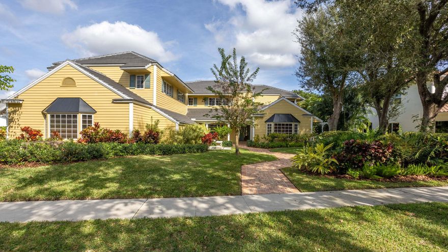 Live The Hamptons lifestyle in Boca Bath & Tennis!  Commanding its place along the community's coveted 14-acre lakefront park, this extraordinary estate delivers 7,654 sq ft. of inspired living where architectural artistry meets timeless sophistication.  From the moment you enter, the home reveals meticulous craftsmanship, soaring volume, and sun drenched spaces that frame the shimmering lake at every turn.  Impeccable craftsmanship is felt throughout the 5+bedroom/6.2 bath home, enhanced by thoughtful architectural design and a warm, inviting floor plan.  Designed to embrace the tropical Florida landscape, the home features expansive impact windows that flood every room with natural light and/or tranquil lake views.  The primary bed enjoys a private sitting area and a large 2nd floor patio overlooking the pool and lake.  For peace of mind, the property includes a whole-house generator and full hurricane-impact glass. At the heart of the home lies a chef's dream kitchen - a dramatic culinary stage appointed with granite surfaces, custom millworker, a commercial-grade gas range, and both a full-size refrigerator and freezer.  The oversized island anchors the space, while the breakfast area captures sweeping patio and lake views that feature patio, garden and lake views that make you feel like you're at a five star resort!  A four car garage , luxurious materials, and meticulous upkeep complete this far offering - one of Boca Bath & Tennis's most compelling lake front homes.