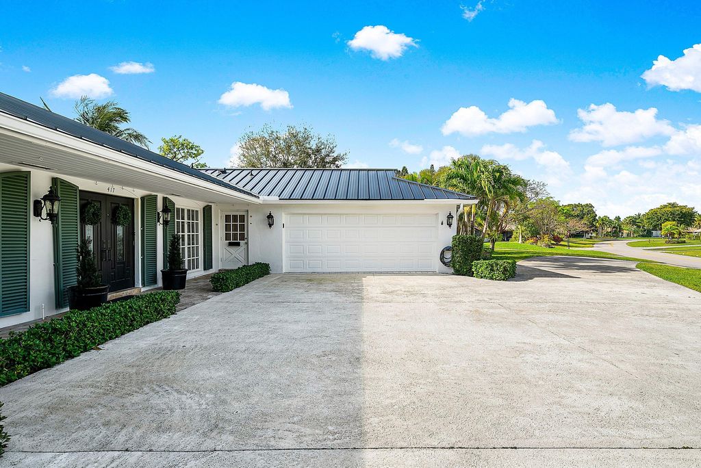 Photo of 417 N Country Club Drive, Atlantis, FL 33462 (MLS # R11169784)