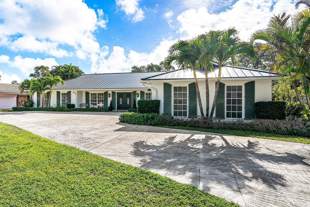 Photo of 417 N Country Club Drive, Atlantis, FL 33462 (MLS # R11169784)