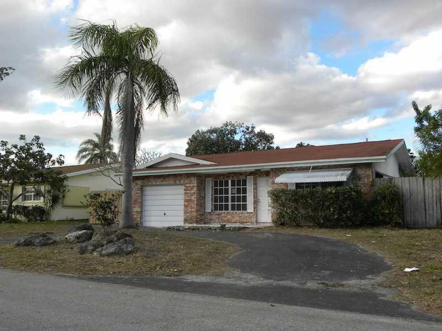 This Palm-Aire Village home has almost 1800 square feet of living space! Featuring a 1 car garage, 3 bedrooms and 2 baths along with a Rear Florida Room, its a great opportunity to move in to a desirable neighborhood. Plus, the wide views of the lake are  hard to beat!  This is a Fannie Mae Homepath owned property. MLS INFO BELIEVED ACCURATE BUT NOT GUARANTEED OR WARRANTED.