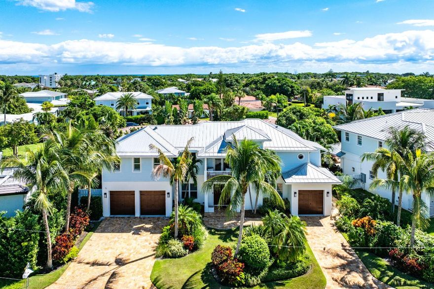 This Coastal Contemporary masterpiece is perfectly nestled between the Intracoastal Waterway and the crystal blue Atlantic Ocean. Lofted ceilings soar above the stunning living room, illuminated by an abundance of natural light and designer lighting fixtures. The floorplan encompasses 3,299 SqFt of exquisite indoor living space comprised of ensuite bedrooms, 3.5 baths, formal dining, breakfast bar, family room, and a 1st floor office/den. A spectacular oversize pool, heated Spa with custom lighting, a loggia retreat and luscious tropical foliage create a tranquil outdoor world in an intimate private setting. Other features include a private elevator, 3-car garage, full house gas generator, astroturf back yard, tankless water heaters and Impact Windows. And just steps to the beach & parks.