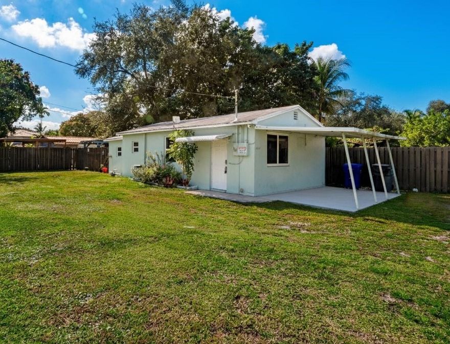 Discover this charming one-bedroom, one-bathroom single-family home in the desirable Hollywood Beach Gardens, available right away. This standalone residence offers ultimate privacy with no shared walls and a private, fully fenced backyard. The interior features clean tile floors throughout, leading to a spacious covered back patio and a convenient covered carport. The home also includes a dedicated laundry room with additional storage space. Enjoy unparalleled convenience and a quiet, secluded feel just minutes from Hollywood Beach, the vibrant Hard Rock Casino, and essential shopping at Publix and Walmart. This private oasis is the perfect blend of seclusion and accessibility in a prime location.