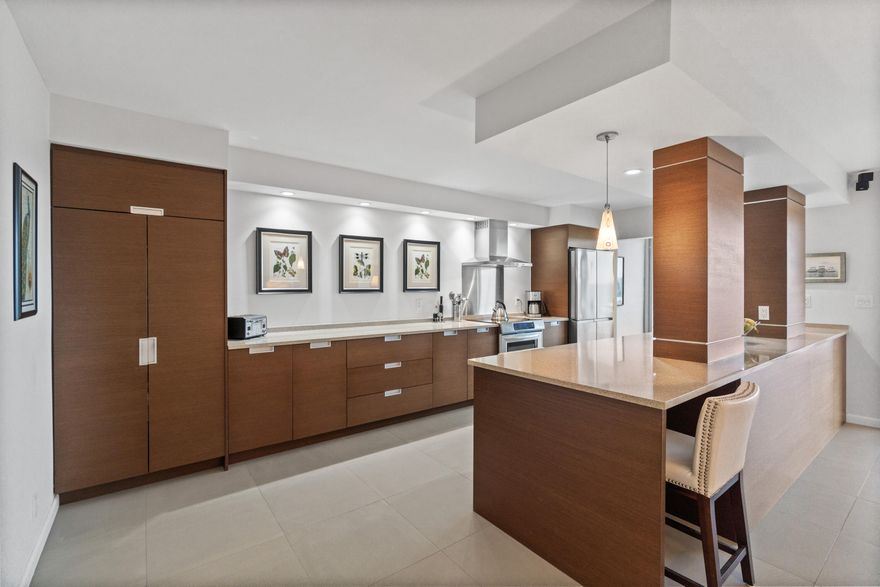 Exceptional designer-built and decorated 2BR/2BA residence at Winton House. This open-concept unit features an oversized kitchen with quartz countertops, newer appliances, pendant lighting, and recessed lighting throughout. Porcelain tile and wood flooring complement the thoughtfully designed interior, including a custom walk-in primary closet showcasing superior craftsmanship. Impact windows and doors plus large sliders provide abundant natural light and overlook the pool and waterfront. Additional highlights include wired sound system, underground covered parking, and recent building upgrades: new roof (2024), fully funded reserves, milestone inspection and SIRS completed. Owner-occupied community with no rentals. Ideally located near beaches, dining, and Lauderdale-By-The-Sea nightlife.