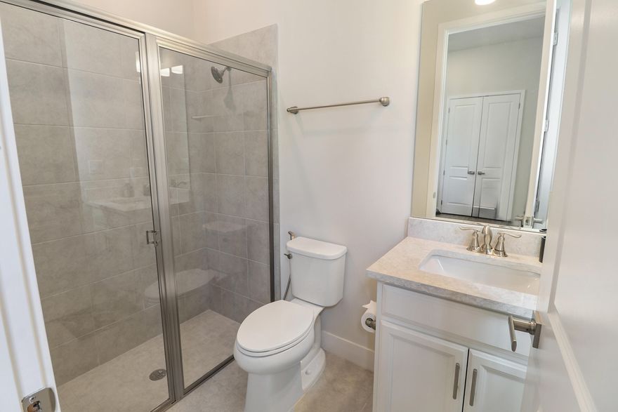 Resort-style living at The Falls at Parkland! This beautifully upgraded home features $80K+ in upgrades and peaceful water views. The desirable triple split floor plan offers 2 bedrooms plus a den/office or optional 3rd bedroom. A spacious great room with volume ceilings is perfect for entertaining. The owner's suite features a spa-like bath with dual shower, quartz vanities, and generous closet space. The gourmet kitchen includes quartz countertops, oversized island, and natural gas cooktop. Additional highlights include impact windows and doors, tankless gas water heater, energy-efficient A/C, and covered lanai with gas BBQ hookup. Located in a gated 55+ community with lawn care included and a 24,000 sq ft clubhouse with resort-style pool, fitness center, café, pickleball, and more.