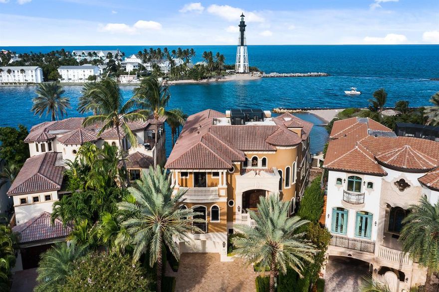 Positioned directly on the Hillsboro Inlet, this unrivaled oceanfront estate encompasses 127' feet of private beach and deep-water dockage for multiple yachts.  Featuring over 9,600 sq/ft, this exceptional compound is perched high above the water and boasts rare and commanding views of the Inlet, the Atlantic Ocean, and the iconic Hillsboro Lighthouse, making this the most prized location from Miami to Palm Beach. Double height walls of glass in all main living areas capture the endless water views and natural beauty that surrounds this 6 bedroom one-of-kind estate.  Features include a Billiard & Game room, Elegant Full Bar, Theater, Wine Tasting Room and secondary Catering Kitchen. Spacious elevated terraces flow to outdoor entertaining spaces that are second to none!