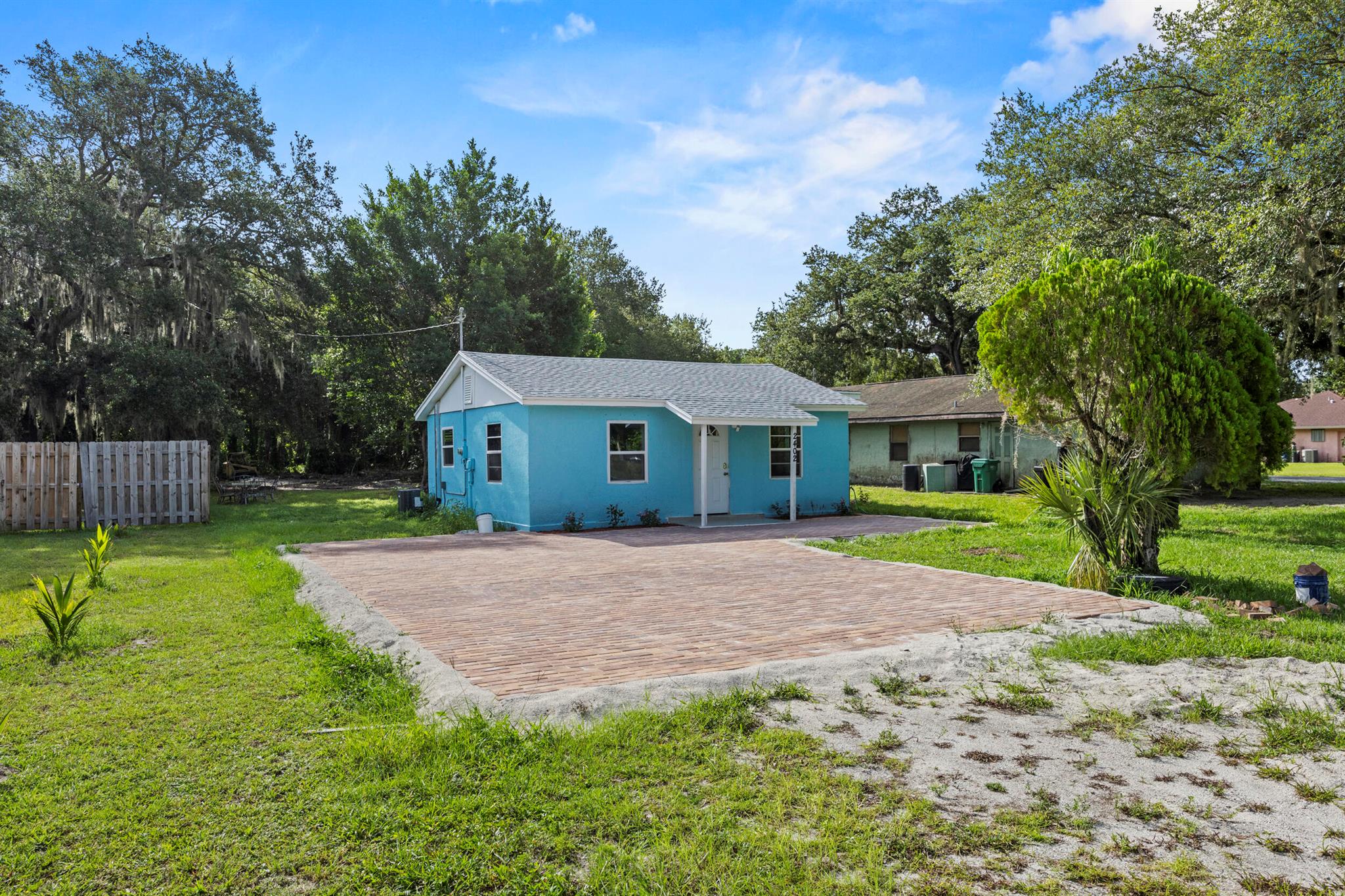 Fully renovated and ready to impress! This charming 2-bedroom, 1-bath home offers 550 sq ft of smart, stylish living with wood-look tile floors throughout, a brand new AC, roof, windows, and doors. Freshly painted inside and out, this home sits on an expansive lot with a paver driveway and plenty of yard space for outdoor living or future additions. Nestled in a quiet neighborhood just minutes from downtown and the beach. Ideal for those who want low-maintenance living with an unbeatable location.