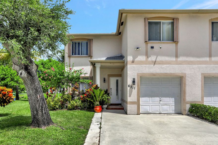 Elevate your lifestyle with this exquisite 4-bedroom, 3-full bathroom townhouse in Margate, epitomizing Tropical Florida living. Enjoy modern luxuries like a new roof installed in May 2023 & AC from 2022, stainless steel appliances, granite countertops, rain soft water system, and more. Relax amidst a private fruit tree oasis by the serene canal. Indulge in the newly renovated master bathroom. With a full bedroom and bathroom on the first floor, convenience is at its peak. Positioned as a corner unit in a peaceful cul-de-sac, convenience meets tranquility. This home won't last - seize your chance to live your Florida dream!