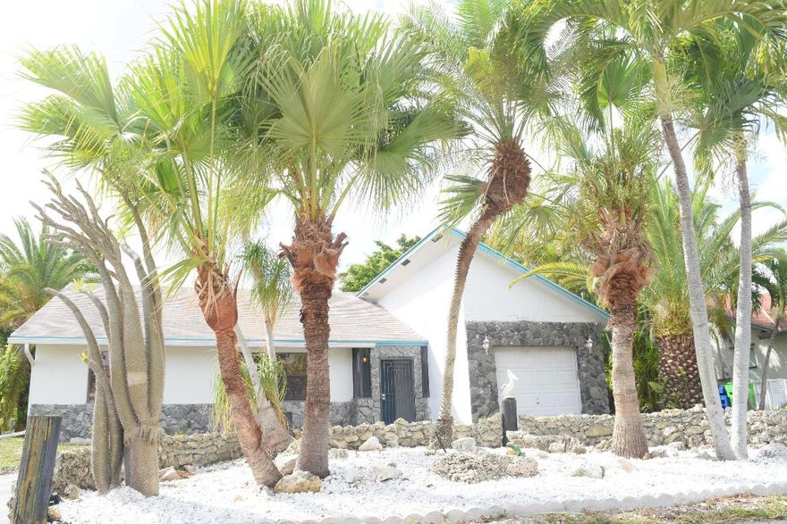 Amazing Never been on the market 3 bedroom 2 bathroom Split Plan with Long Lake Views Super Private! This beauty is nicely landscaped with a Rock Garden and a circular driveway wrapped around it to accommodate plenty of parking!From the second you walk into the house the attraction is to look at the incredible lake views this one is special you can update a house but you cannot update a view! Awesome High Ceilings and tile throughout except for the second bedroom has brand-new carpet! Kitchen has all stainless steel appliances and the pass-through window to the large tiled screened in porch approx.450sqft can accommodate large gatherings with family and friends!  Make your way out to the large backyard kickback in your easy chair do some therapeutic fishing and relax! Come take a look!