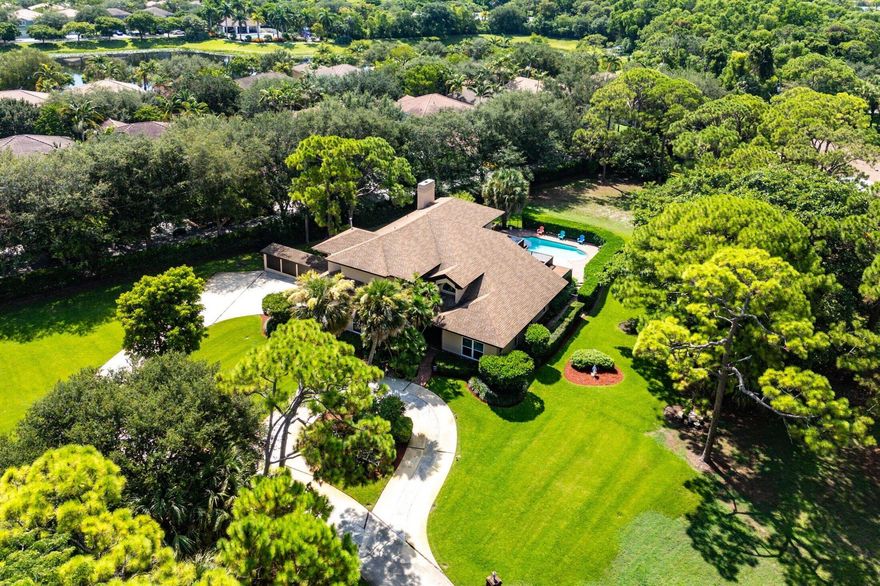 This exceptional property represents a rare offering, providing unprecedented potential for the discerning purchaser seeking a special parcel available for the first time in over 40 years. The three-acre estate, located just east of Military Trail, is a surprisingly secluded offering so near to the amenities of downtown Delray Beach.The current residence is a classic, country-style family home, thoughtfully designed and meticulously maintained, featuring four bedrooms, 4.5 bathrooms, a private pool, and a two-car garage, all nestled among mature pines and oaks.The sprawling three-acre parcel includes a large utility structure ideal for boat or camper storage, in addition to a separate shed for tools and equipment. The majority of the parcel sits at or above a 16′ elevation.