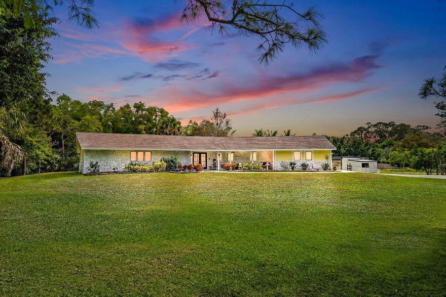 Nestled in a prime location near Indiantown Road, this beautifully appointed 4-bedroom, 3-bath home combines space, privacy, and versatility with a desirable split floor plan. A standout feature is the dual primary-style suites, ideally positioned on opposite sides of the home, each offering its own ensuite bath—perfect for multigenerational living, guests, or added privacy. Situated on a generous 1.25-acre lot, the property provides a peaceful setting while still offering quick and convenient access to major roadways. The primary suite features a newly remodeled bath, adding a touch of modern luxury. The main living area includes a cozy wood-burning fireplace, creating a warm and inviting atmosphere. The spacious back patio overlooks the expansive backyard and offers an ideal setting... for outdoor dining, entertaining, or relaxing while enjoying the privacy and natural surroundings. With plenty of room to customizewhether envisioning a pool, garden, or outdoor living spacethe patio serves as a seamless extension of the home's indoor living areas. Located in the sought-after Winterhawk section of Jupiter Farms, this home includes recent system updates such as a new hot water heater (2025), AC (2020), re-bedded water system (2024), and a reverse osmosis system at the kitchen sink. This exceptional property presents a wonderful opportunity for the right buyer to update and make it their own while enjoying both tranquility and accessibility in one ideal setting.