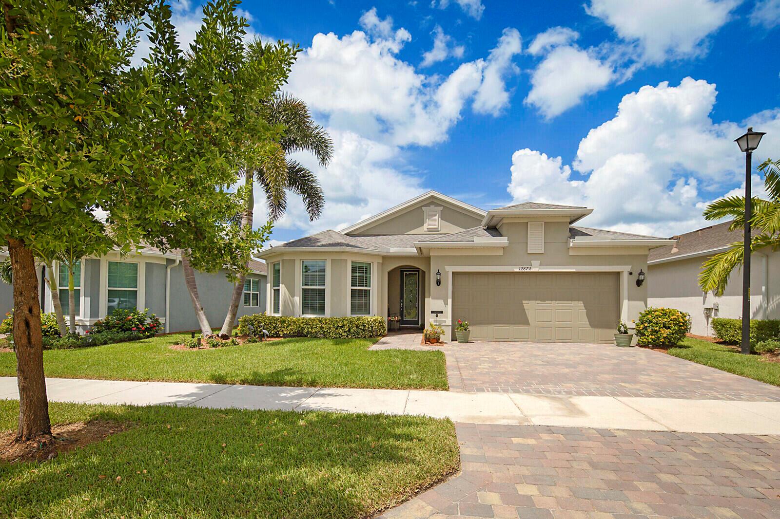 Experience Florida living at its finest in this beautifully upgraded Summerwood model in the sought-after Del Webb Tradition 55+ community. This extended layout offers over 2,000 sq ft under air, featuring 2 spacious bedrooms, a den/flex space, and 2 full bathrooms. Step into a light-filled open-concept living area with upgraded tile floors, a gourmet kitchen with granite center island, and seamless flow to the outdoor oasis - an extended screened lanai with a custom heated pool, surrounded by lush landscaping and serene views, ideal for both quiet mornings and year-round enjoyment and entertaining. WHY WAIT TO BUILD ? MOVE IN NOW AND START ENJOYING THE FLORIDA LIFESTYLE YOU'VE EARNED.