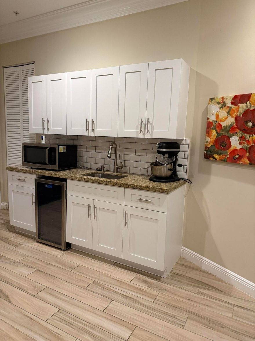 Stunning Pearl model townhouse, rarely available, offers four bedrooms and 3.5 bathrooms. It features an elevator, immaculate condition, and a kitchenette on the first floor. The enormous kitchen includes an island. Custom master closets and wood tile throughout add to its appeal. The upgraded staircase, railings, and end unit with ample natural light make it a desirable living space. Professional photos will be available soon.