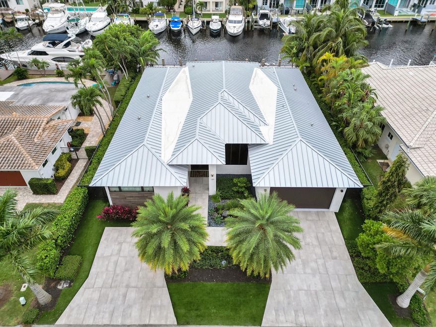 Waterfront 2022 Custom built to the latest regulations home offering elegance and modern luxury living. Nestled on one of the highly desired Las Olas Isles for its high elevation, no flooding, deep canal, and wide street with utilities underground lined with Majestic Royal Palms. Contemporary One-story design w/over 4,500sf of seamless indoor-outdoor living providing a perfect blend of chic indoor sophistication & outdoor serenity. Open floor plan, 12' ceilings, gourmet kitchen w/oversized exquisite island & top-of-the-line appliances. The lavish primary features walk-in closets & spa-like bathroom. Stunning water views from floor-to-ceiling glass doors. Covered patio w/summer kitchen. 85' dock easy ocean access-no fixed bridges. Ultra-secure location while steps away from dining & beaches