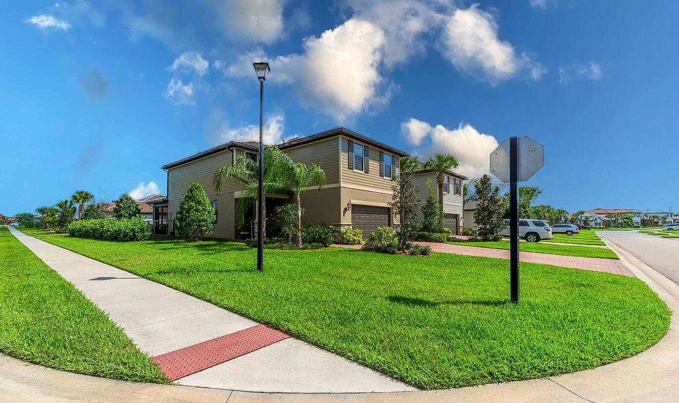 Moving Sale! Sellers are offering to pay buyer's closing costs--don't miss this opportunity! This rarely available Divosta Driftwood model sits on a premium corner lot and offers a spacious, flexible layout with 4 bedrooms and 4.5 bathrooms--plus den for home office or media room. Light and bright with luxury vinyl flooring throughout, impact windows, and plantation shutters. The grand foyer leads to an open concept living area. The oversized primary suite includes a sitting area, spa-like bathroom, and huge walk-in closet. Enjoy tranquil lake views from the extended screened patio--ideal for entertaining. Epoxy-coated 2car garage. Resort-style amenities: pool, spa, gym, tennis, BBQ. HOA covers lawn care, irrigation, security, and more. Prime location near Turnpike, shopping, and beaches