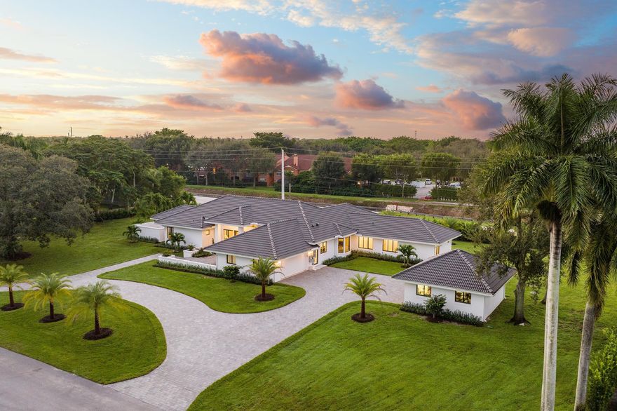 Completely remodeled in 2022, this 4 bed + office ranch home sits on a vast 1-acre lot in gated Fieldbrook Estates. Step inside to tall ceilings and an abundance of natural light. The kitchen is a culinary dream with Wolf and SubZero appliances incl. gas range, a wet bar, wine coolers and walk-in pantry. Spacious living areas and primary suite with expansive views of the pool and backyard. Retreat to the primary suite's spa-like bathroom. All bedrooms feature built-in closets and en-suite access. Impact windows, new driveway, generator, and 400 amp power this home offers both style and security. The expansive 1 acre lot presents the opportunity to expand and customize your dream home or outdoor space. Additional structure presents even more opportunity. Boca A+ schools