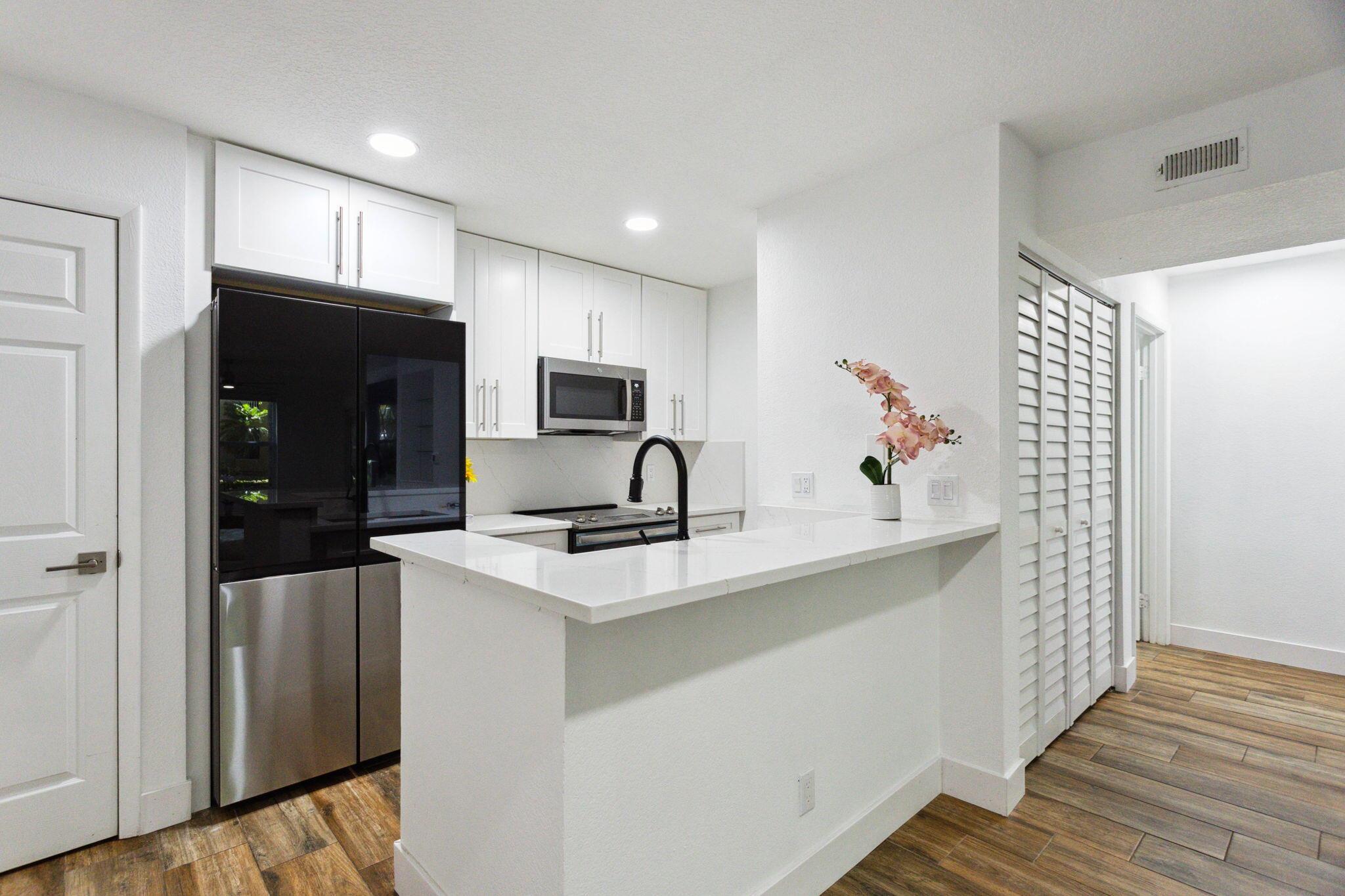 Verano at Delray is a beautiful gated condo community in Central Delray Beach that welcomes all ages. Located on Linton Boulevard just west of I-95 you'll enjoy the outdoors as much as the confines of your condo. This fully renovated 1 bedroom 1 bath corner unit boosts an abundance of natural light and is fully equipped with modern appliances. The unit conveniently comes with a new smart washer and dryer, AI family hub 4 door refrigerator, smart dial duo air fry oven, and a spacious garage complete with pristine epoxy flooring. Amenities include tennis courts, a private clubhouse, a fitness center, and a luxurious swimming pool.