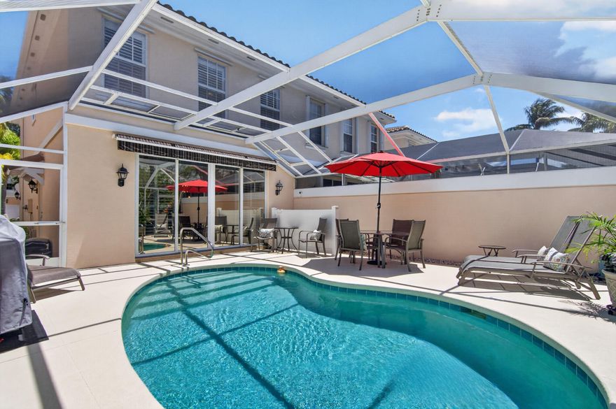 Welcome to 423 Capistrano in desirable Catalina Lakes—a meticulously maintained, fully furnished corner townhome offering privacy, upgrades, and effortless Florida living. This immaculate 3-bedroom, 2.1-bath residence (with a flexible third bedroom/office featuring a closet) showcases pride of ownership throughout.  Enjoy your own private outdoor retreat with a screened-in heated pool, fenced yard, and open patio with retractable awning—perfect for year-round entertaining. Eastern front exposure and western rear exposure provide beautiful natural light throughout the day.  The expanded and remodeled kitchen (2022) features quartz countertops, marble backsplash, gray wood cabinetry, and premium appliances including KitchenAid and LG. Bathrooms were also tastefully updated in 2022.  Interior finishes include a blend of wood, tile, and carpet, complemented by plantation shutters and thoughtful design details.  Additional highlights include:  New tile roof (2023) - assessment paid at closing A/C (2024 Daikin) with 12-year warranty & sanitized ducts Hot water heater (2020) Heated pool with new pump and heater Central vacuum system Upgraded electrical panel Smart home features including Nest doorbell & camera Built-in garage cabinetry + 1-car garage Hurricane protection (metal shutters) Offered furnished with exclusions, this move-in-ready home is ideal for seasonal or full-time paradise living. Catalina Lakes HOA includes basic cable & internet, adding convenience and value. Amenities include community pool, clubhouse, playground, & pickleball courts. Showing by appointment only